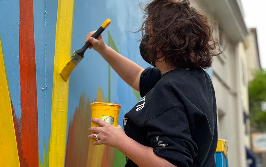 Woman painting mural